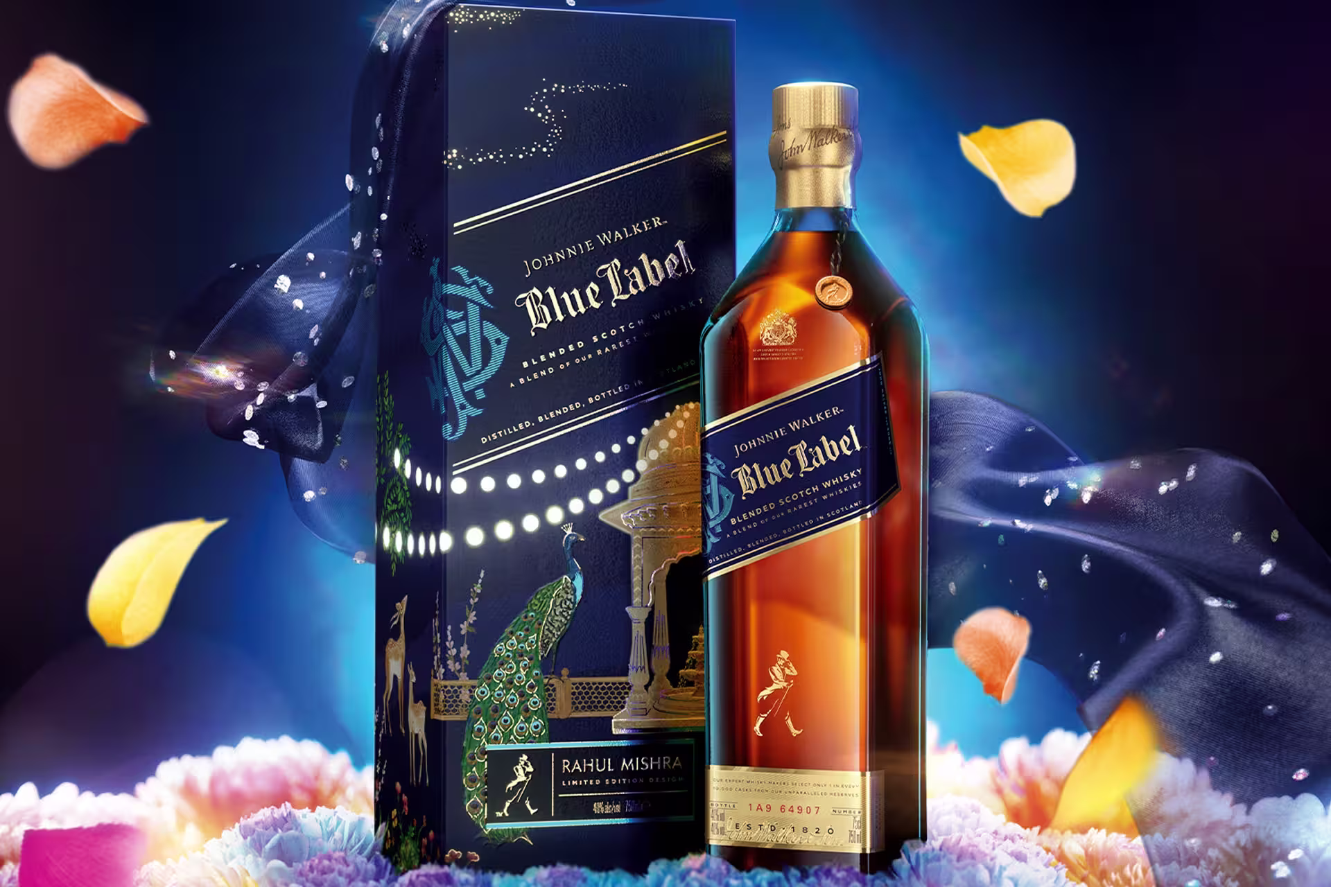A bottle of Johnnie Walker Blue Label whisky stands next to its decorative blue and gold box, surrounded by floating petals and vibrant, colorful flower petals, with a dark, glowing, celebratory background.