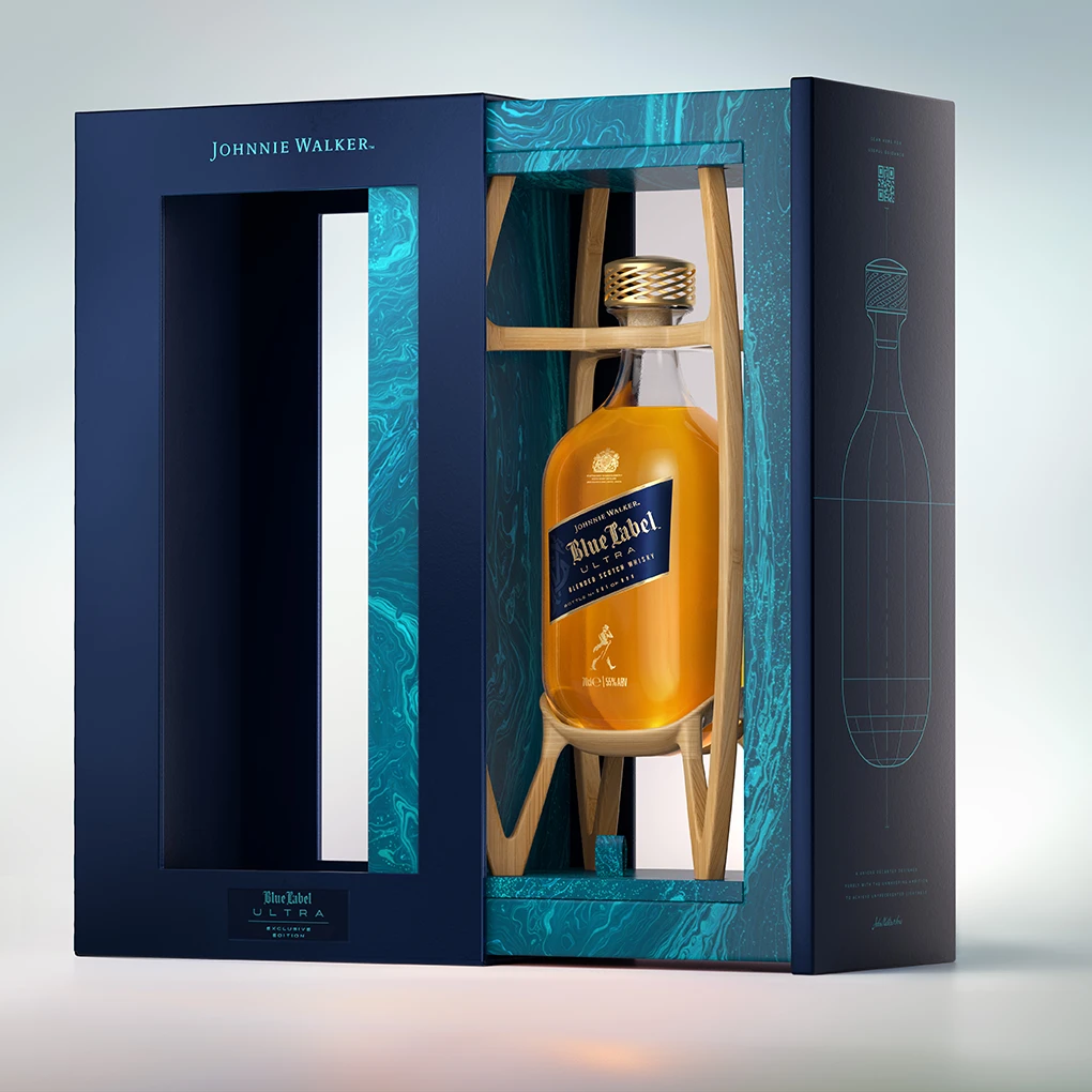 A bottle of Johnnie Walker Blue Label Ultra whisky displayed in an elegant blue and teal box with gold accents, featuring a cut-out window and a modern, artistic interior design.