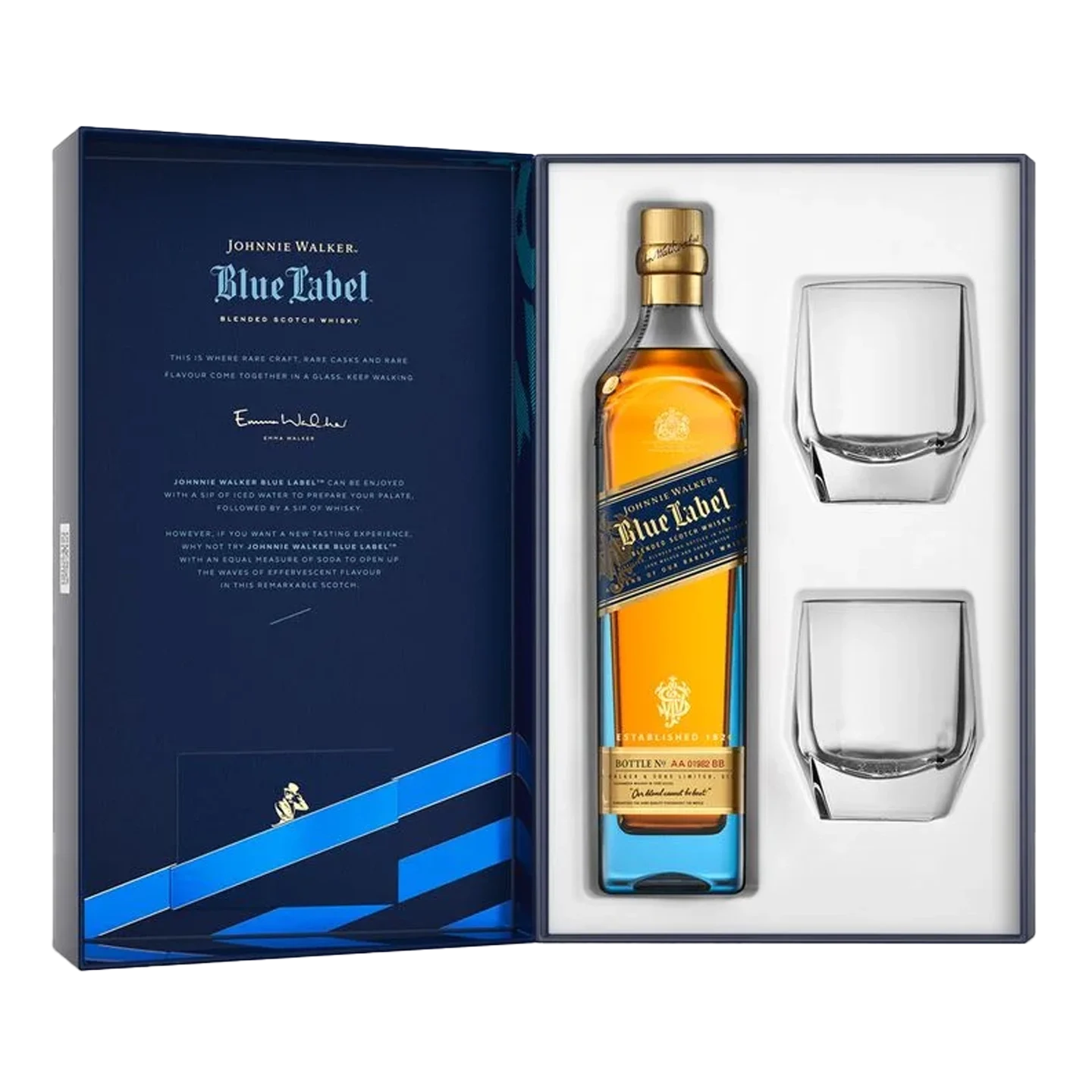 A bottle of Johnnie Walker Blue Label whisky stands next to its decorative box on a table with two filled glasses, a cork, and gold ribbon, with warm bokeh lights in the background.