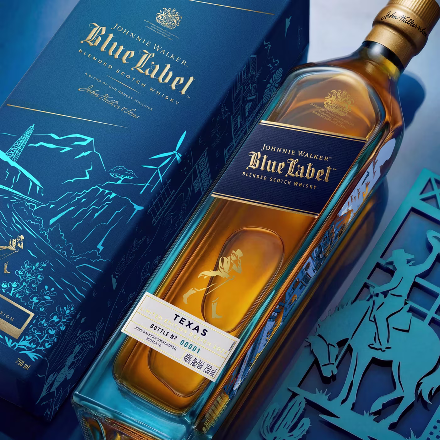 Johnnie Walker Blue Label Texas edition bottle next to its blue box with Texas-themed illustrations.