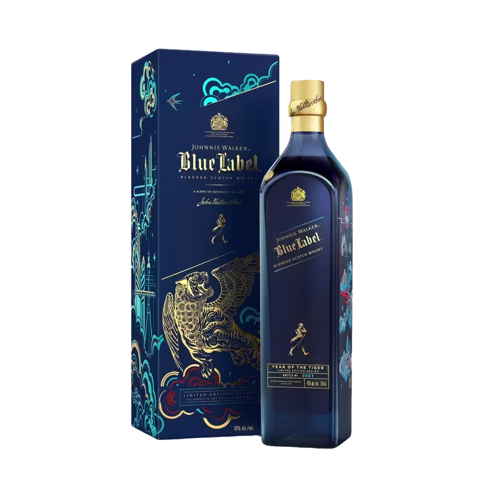 A Johnnie Walker Blue Label bottle and its decorative box featuring intricate gold and blue designs with an artistic depiction of a tiger. The bottle has a gold cap and the box includes elegant branding elements.