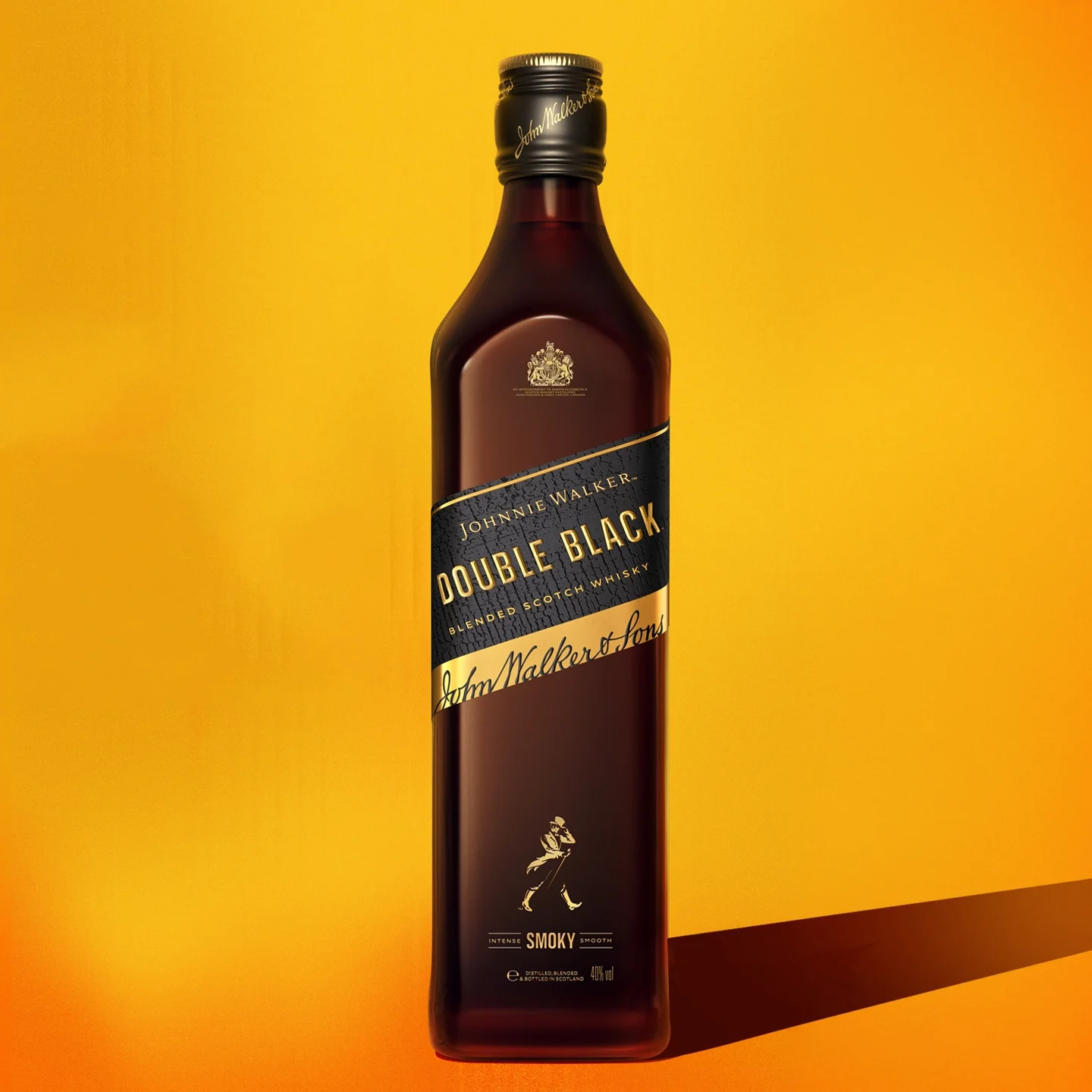 A bottle of Johnnie Walker Double Black whisky stands upright against a bright yellow-orange background, casting a shadow to the right. The label is predominantly black with gold lettering.