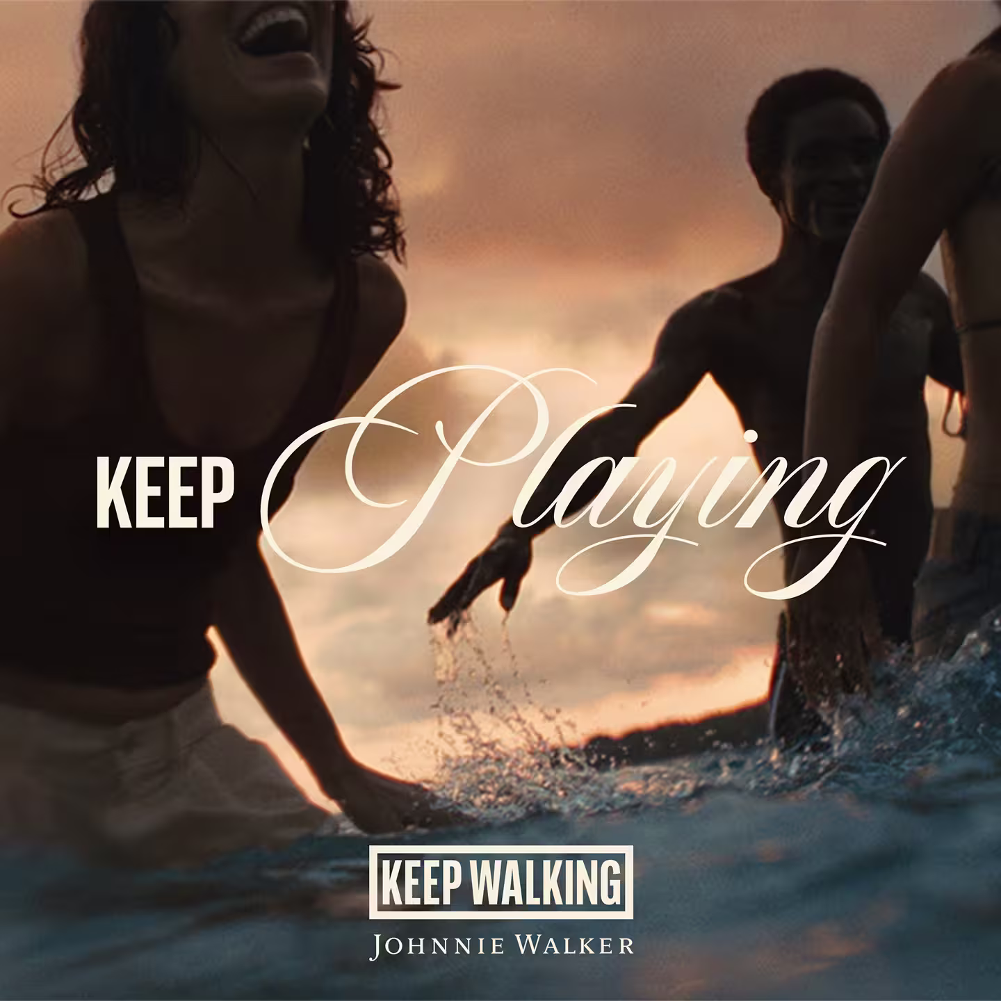 Three people laugh and play in the water at sunset. The overlaid text reads Keep Playing and Keep Walking Johnnie Walker. The scene feels joyful and carefree.