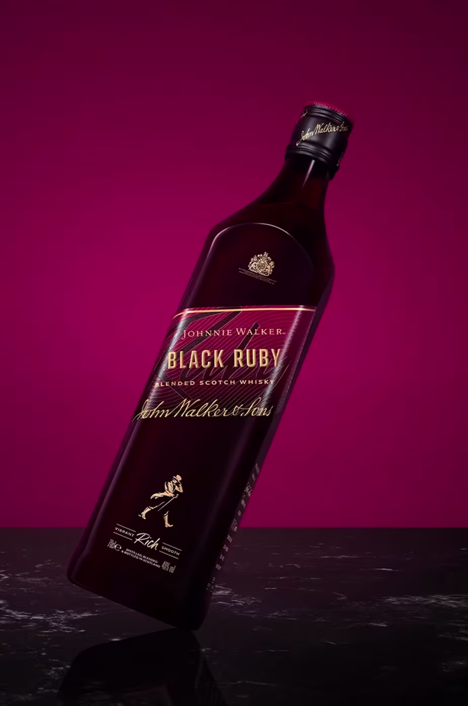 A bottle of Johnnie Walker Black Ruby against a deep magenta background.