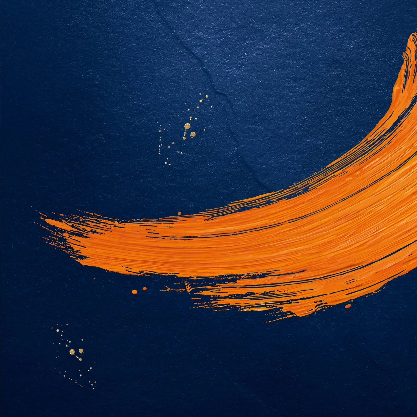 An abstract image with a broad, sweeping stroke of vivid orange paint against a dark blue textured background. Small splashes of orange are scattered around the brushstroke.