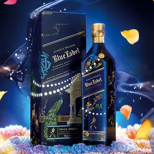 A limited edition Johnnie Walker Blue Label bottle and box featuring intricate, colorful designs with peacocks, flowers, and a pavilion, set against a dark blue background with floating petals and soft, colorful lighting.