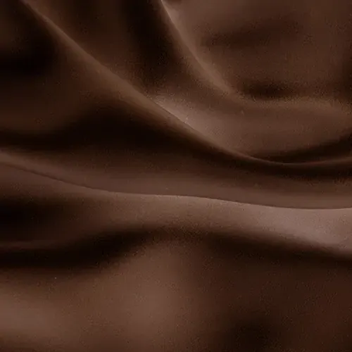 Smooth brown satin fabric with gentle folds and a shiny shimmer that reflects the light. The texture appears soft and luxurious, suggesting elegance and wealth.