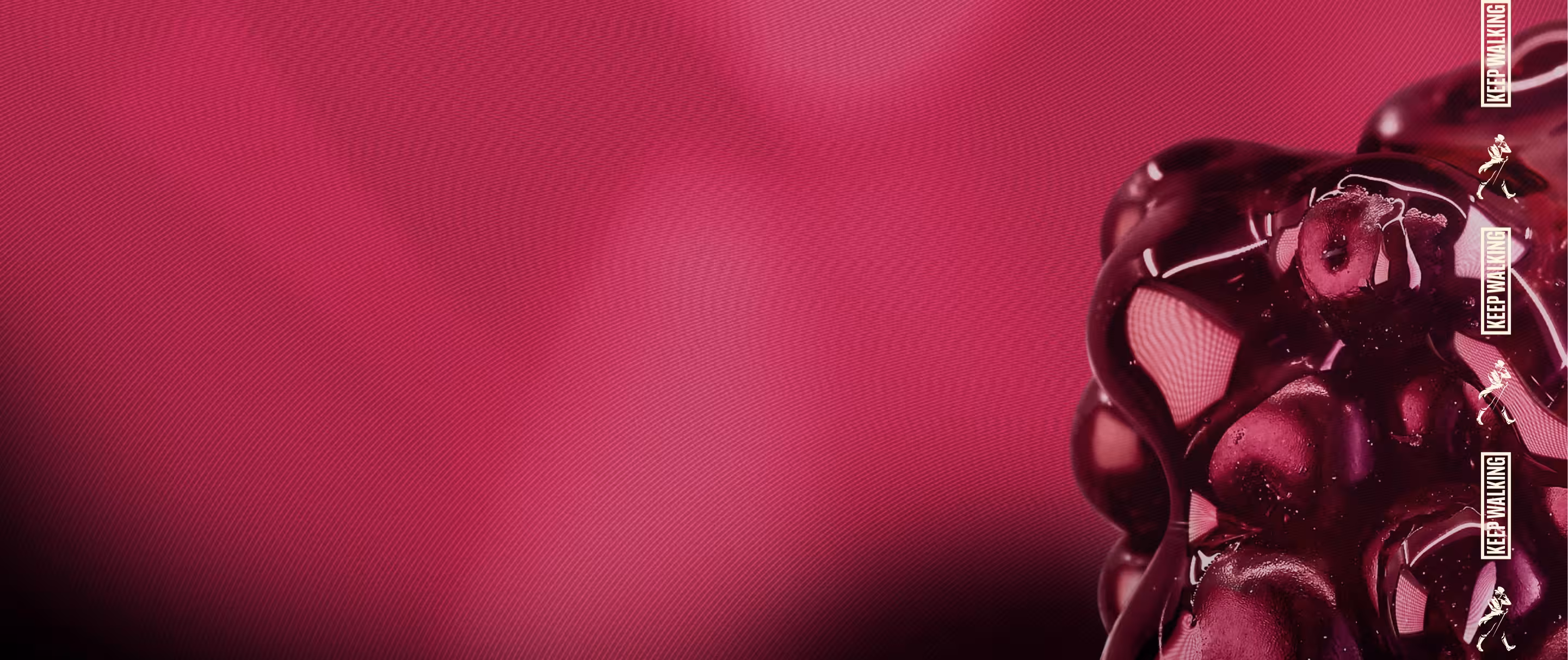 Primer plano de cerezas negras con un brillo brillante sobre un fondo rosa vibrante. Tres pequeñas etiquetas con el texto KEEP WALKING (Sigue caminando) están alineadas verticalmente cerca de la esquina superior derecha.