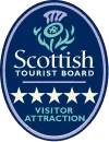 Emblema ovalado de color azul con un diseño de cardo en la parte superior, con la leyenda Scottish Tourist Board (Oficina de turismo escocesa). Debajo, se lee 5 Star Visitor Attraction (Atracción turística de 5 estrellas) con cinco estrellas blancas.