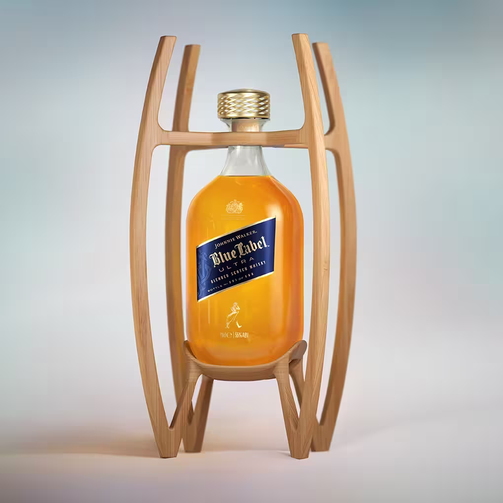 A bottle of Johnnie Walker Blue Label whisky is displayed in an elegant wooden stand with curved supports, set against a softly blurred light blue and white background.