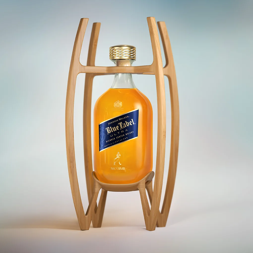 A bottle of Johnnie Walker Blue Label whisky is displayed in an elegant wooden stand with curved supports, set against a softly blurred light blue and white background.