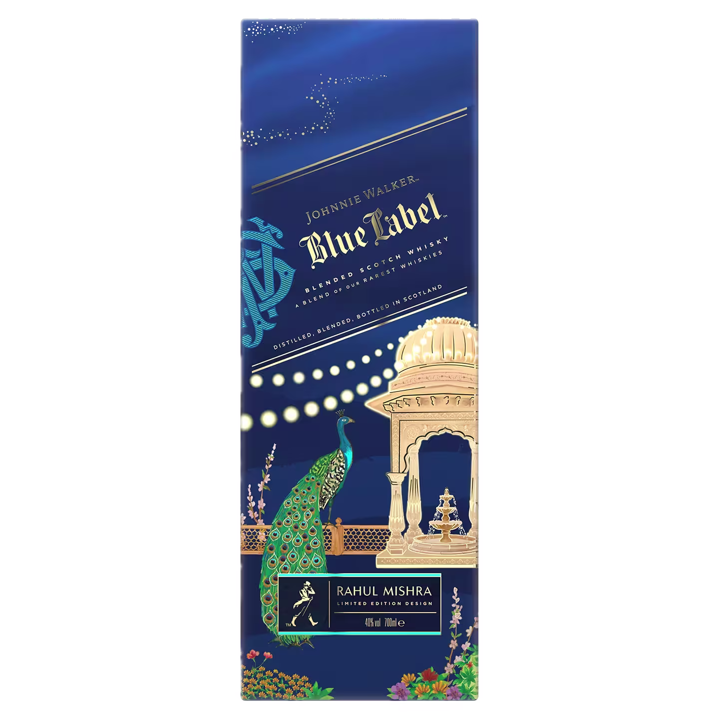A decorative Johnnie walker blue label x rahul mishra limited edition design box featuring gold text, an illustrated peacock, ornate architecture, and floral patterns on a deep blue background. The box highlights a collaboration with Rahul Mishra.