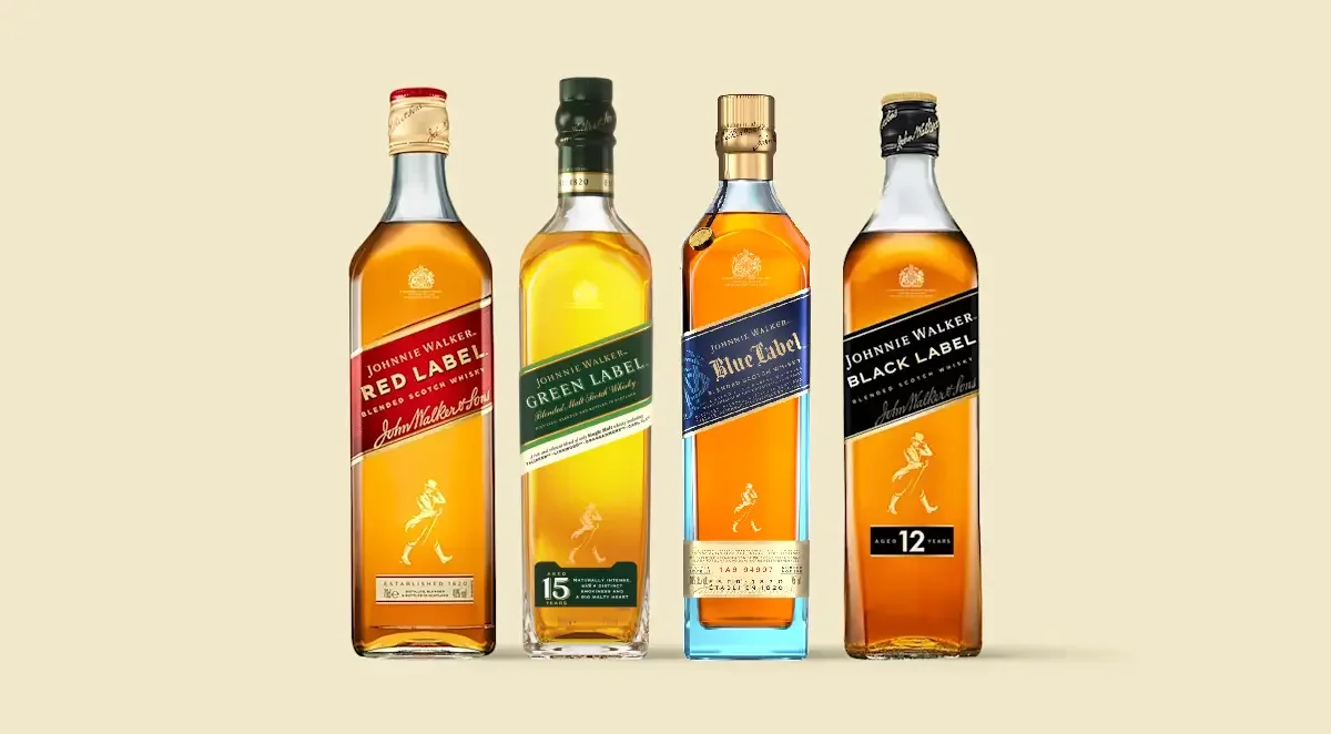 Four bottles of Johnnie Walker whisky—Red Label, Green Label, Blue Label, and Black Label—stand side by side on a light beige background, each with distinct colored labels.