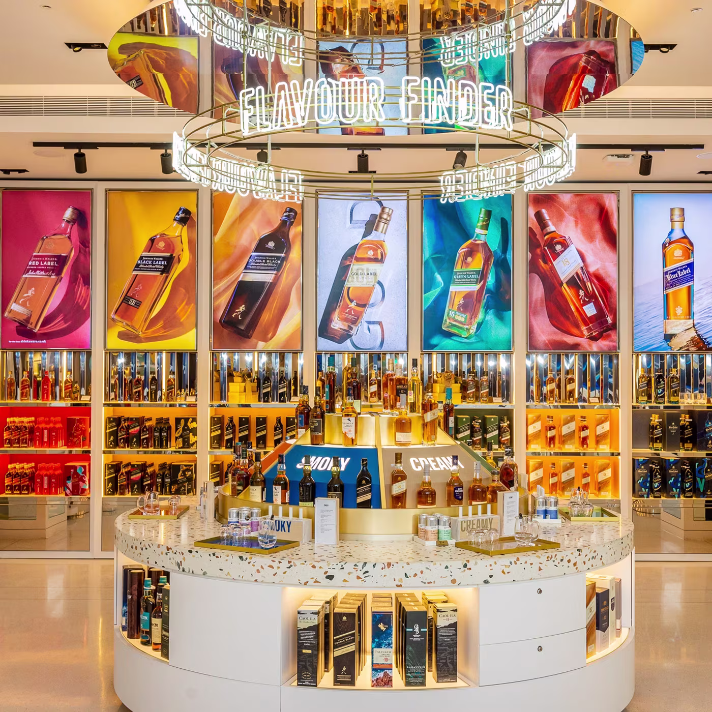 A whisky store display with bottles, shelves, and bright neon FLAVOUR FINDER sign overhead.