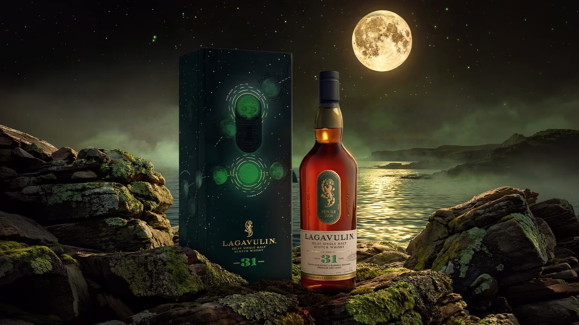 A Lagavulin 31 whisky bottle and box on rocky terrain with a full moon over a misty lake at night.