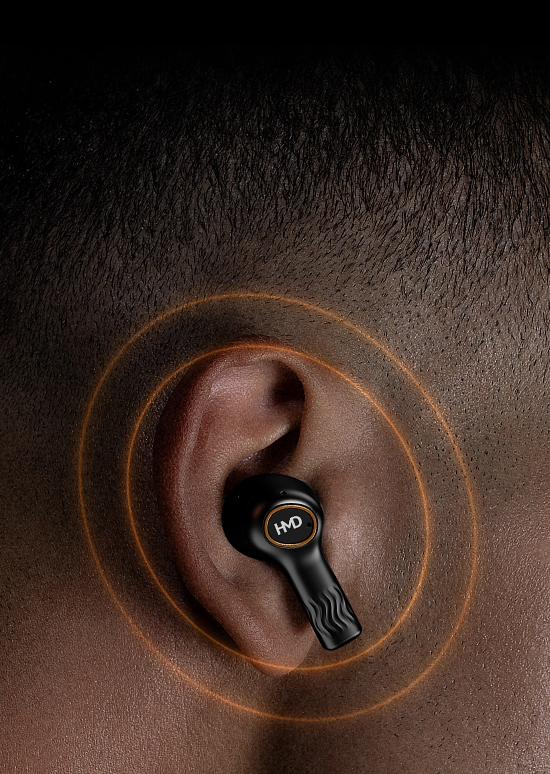 Black wireless earbud in ear with orange sound waves, close-up. Audio technology, sleek design.