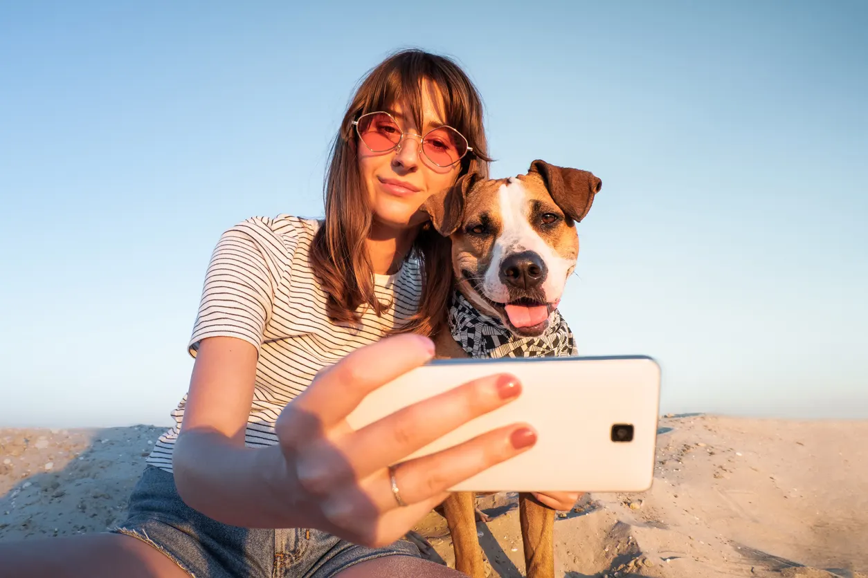 woman posing with dog for selfie