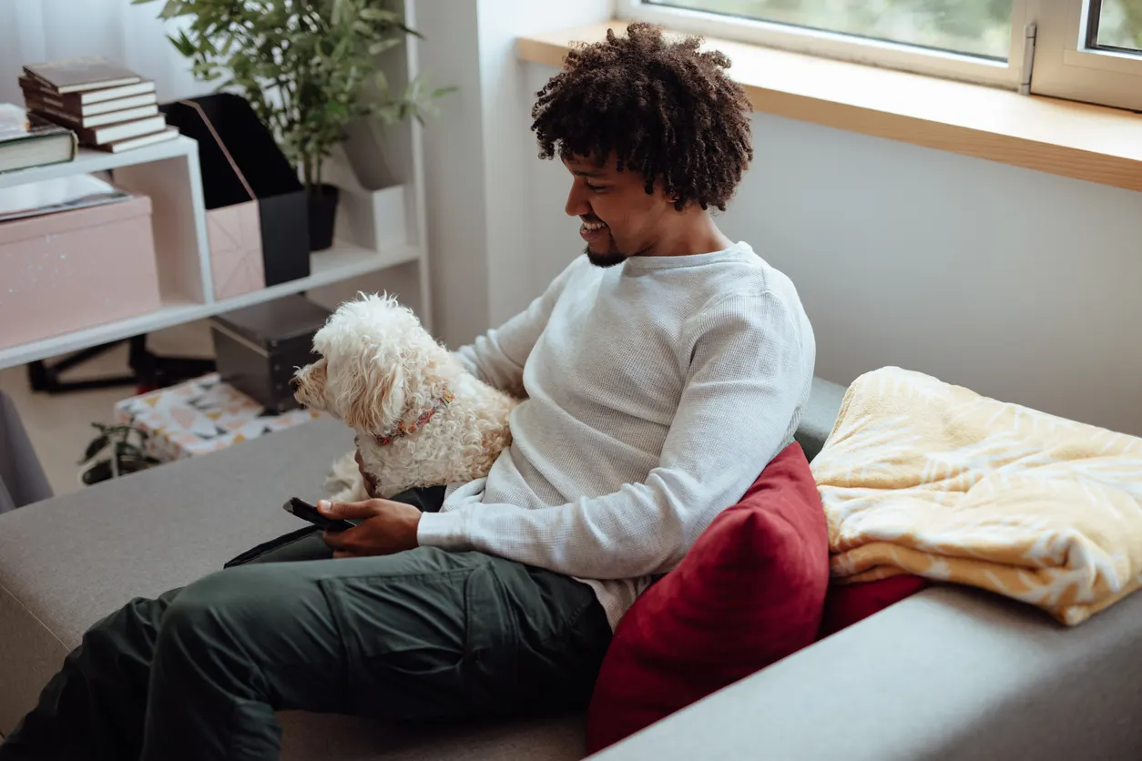 Man watches tv with his dog
