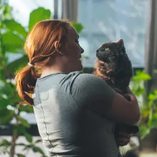 woman standing with cat