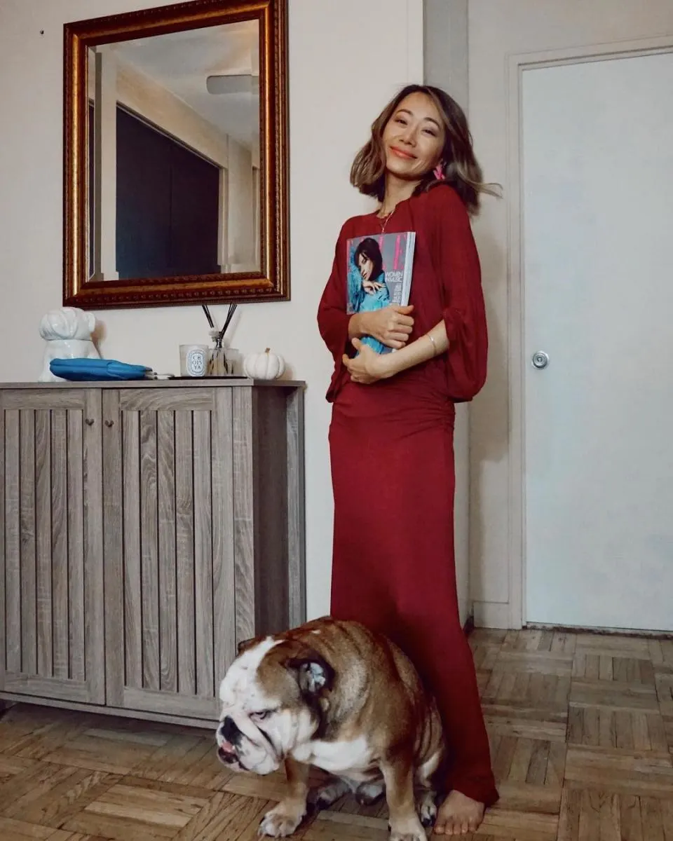 girl standing in apartment with bulldog