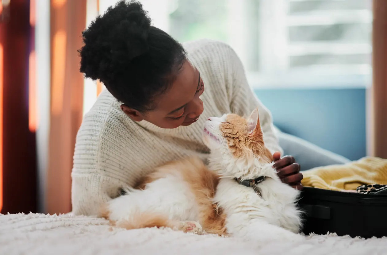 woman cuddles with cat