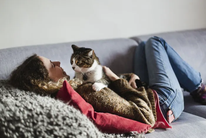 cat cuddling on lady