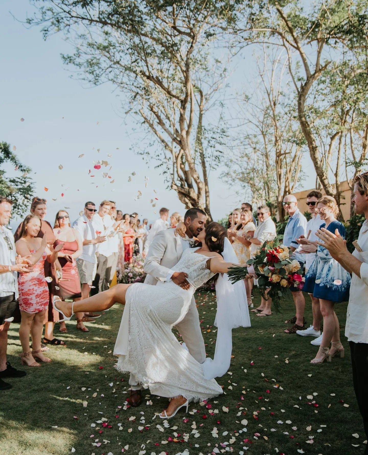 couple celebrates wedding surrounded by family members in Bali