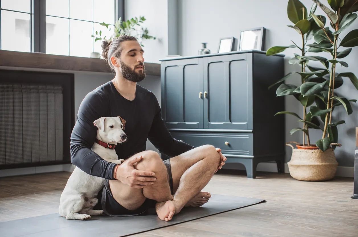 man and dog meditate together