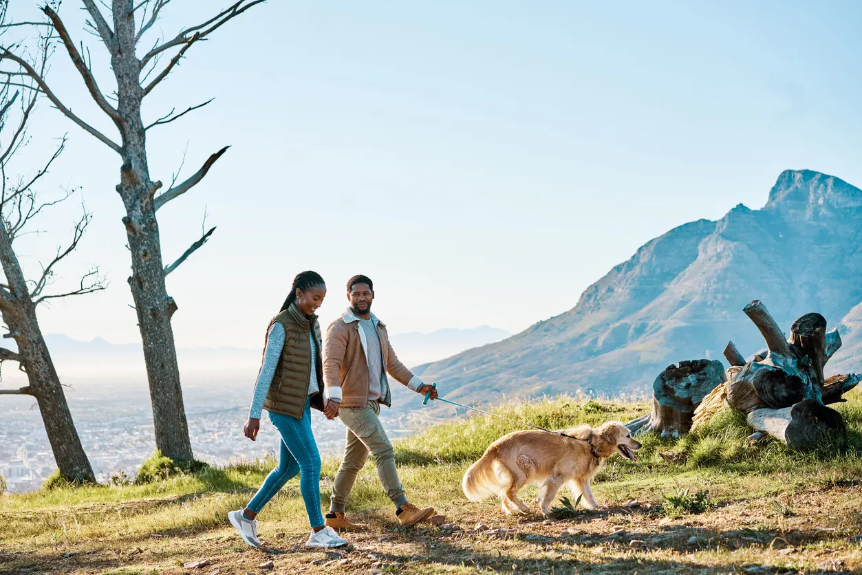 young couple hiking with dog