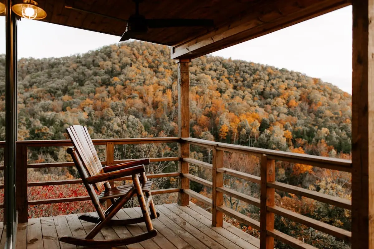 two chairs on porch overlooking woods