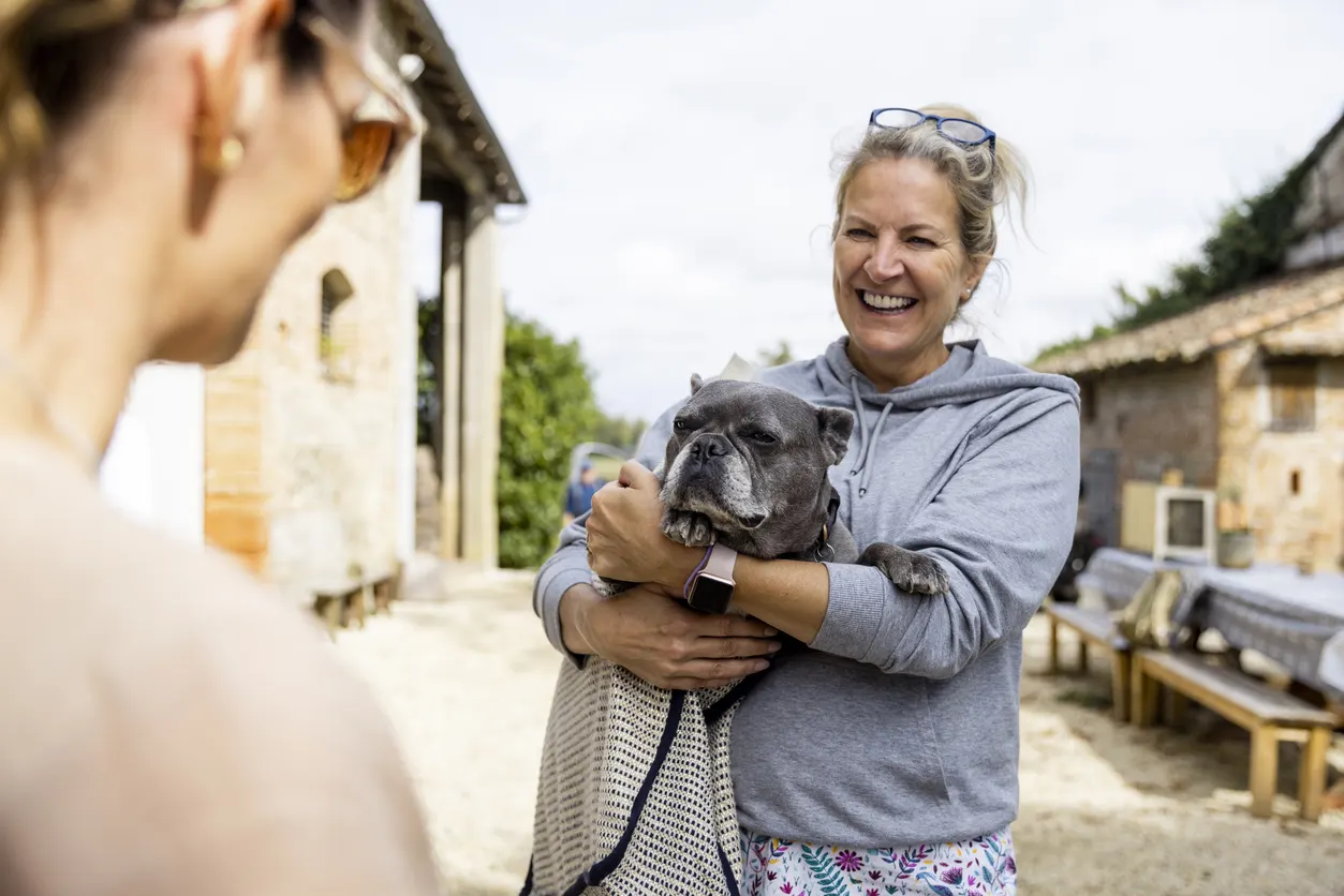 woman holding french bulldog