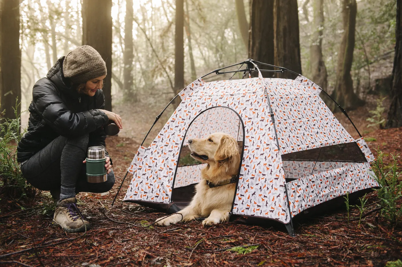 woman looking at her pet dog in a dog tent