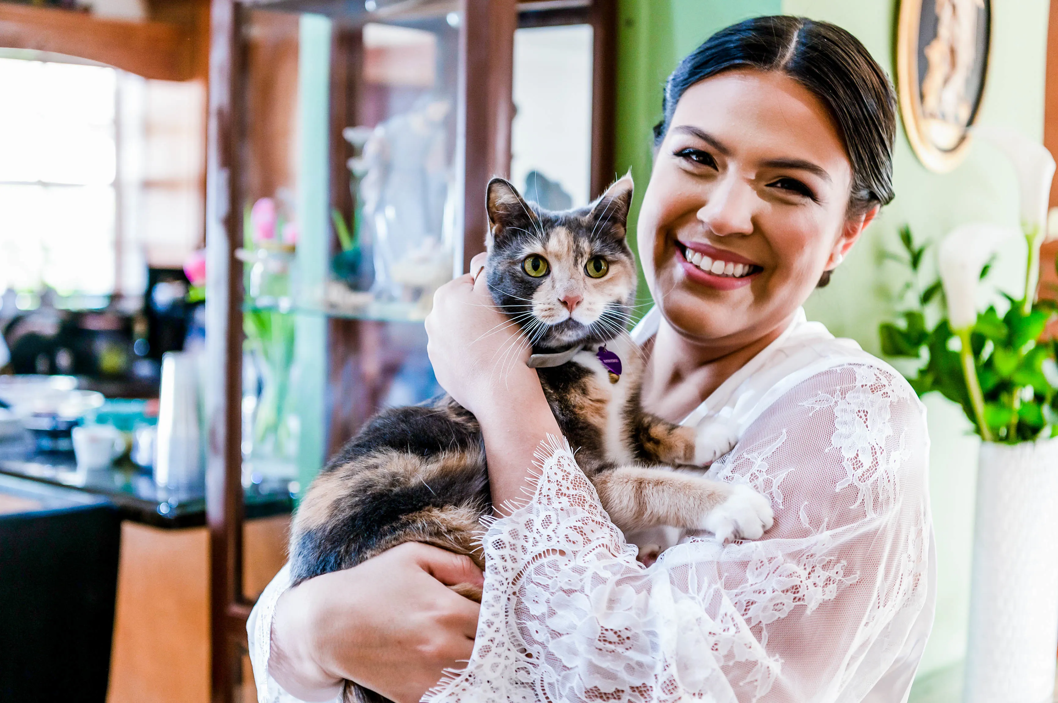 woman posing with cat on wedding day