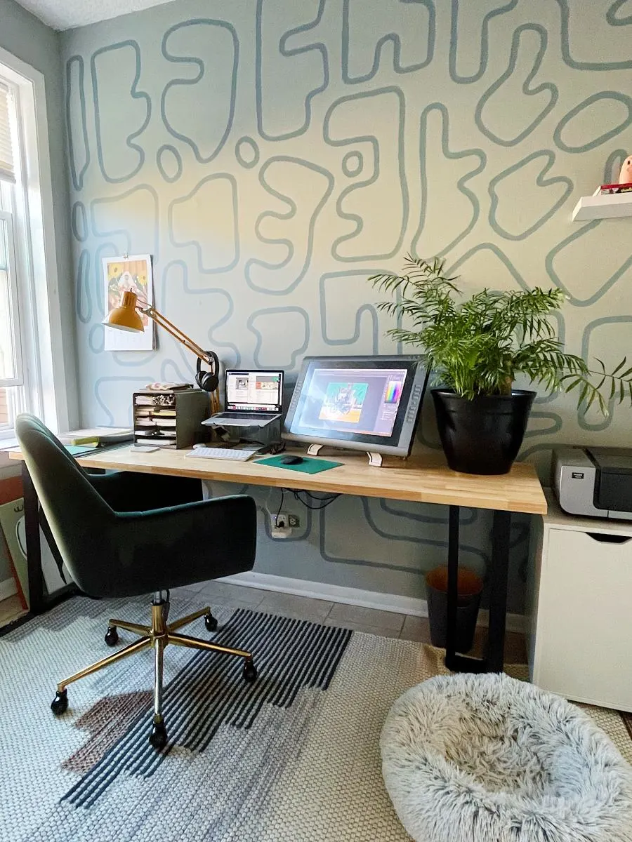 Office with wall mural painted behind desk