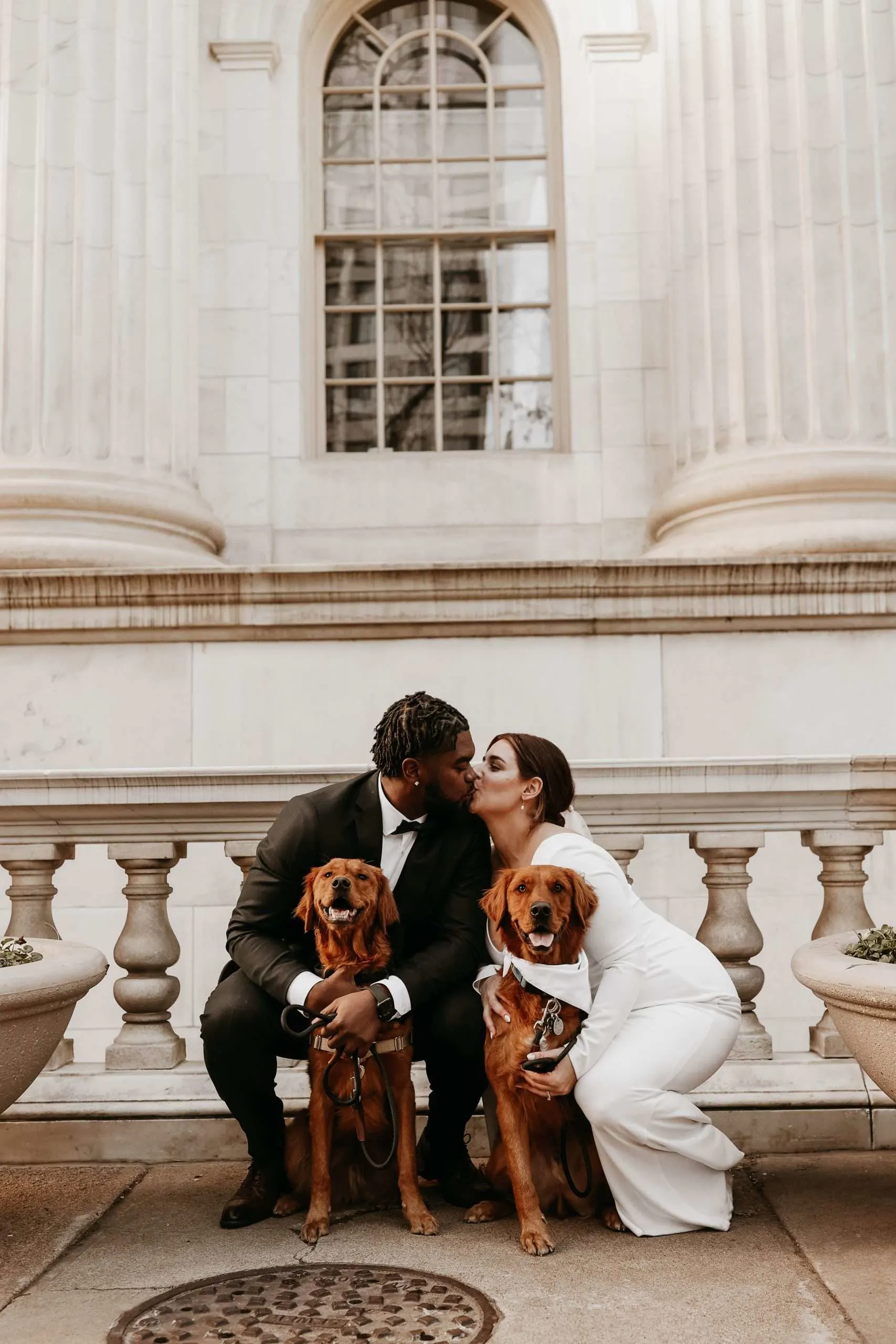 couple shares a kiss after eloping in downtown Denver with their two dogs