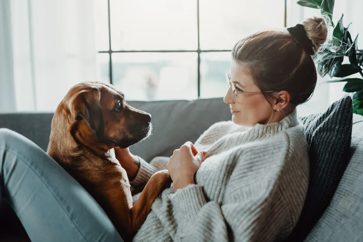 Woman staring at brown dog lovingly