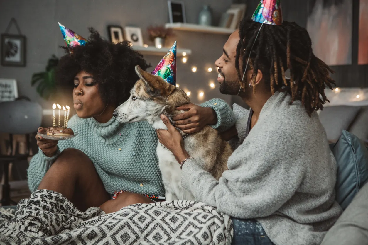 man and woman celebrate dog's birthday