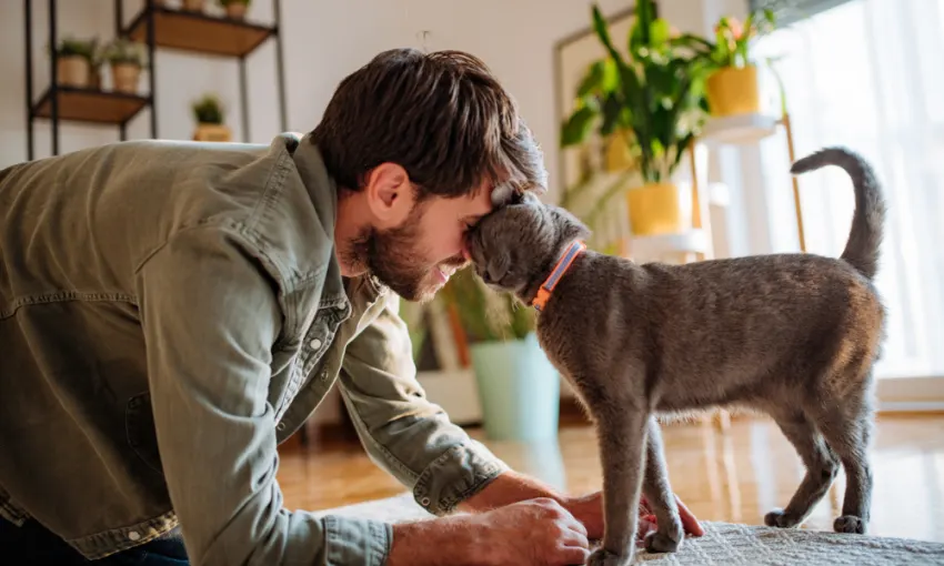 man cuddling cat