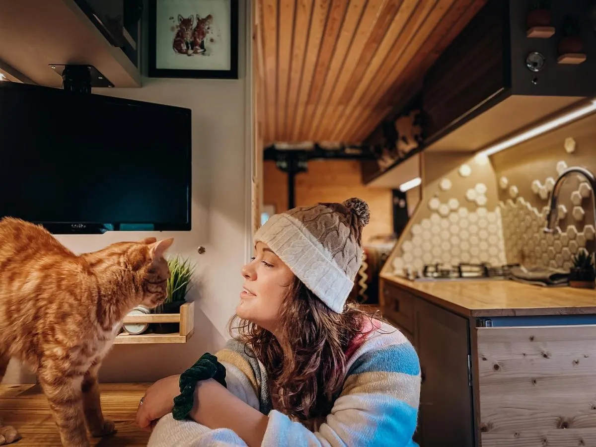 woman and her cat in a van