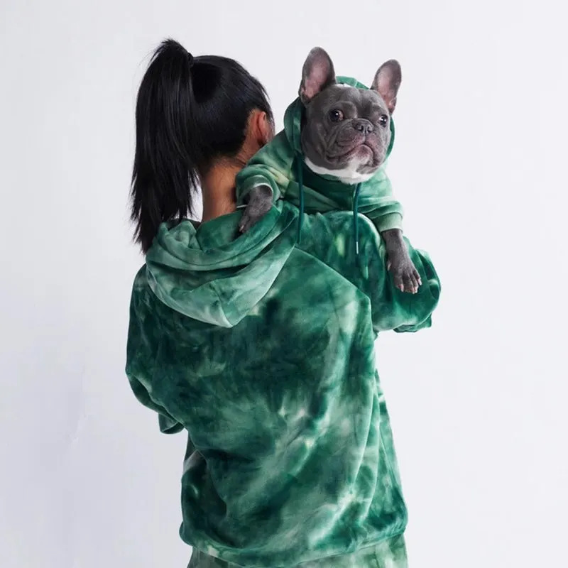 Woman in green hoodie with frenchie in matching green hoodie