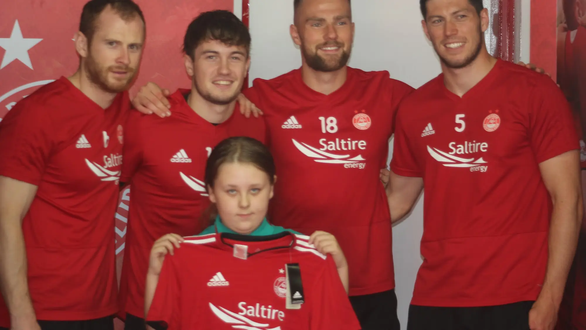 Dons supporter receives shirt from DNA member