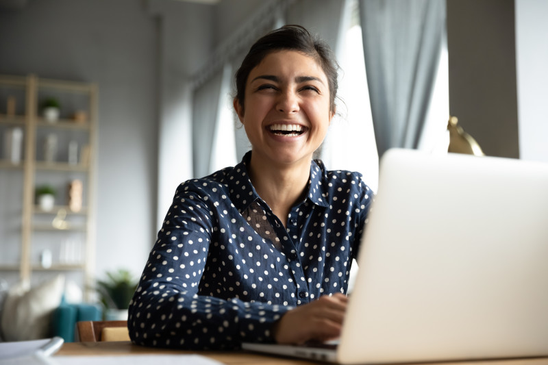 shutterstock 1606120384 woman smiling at laptop