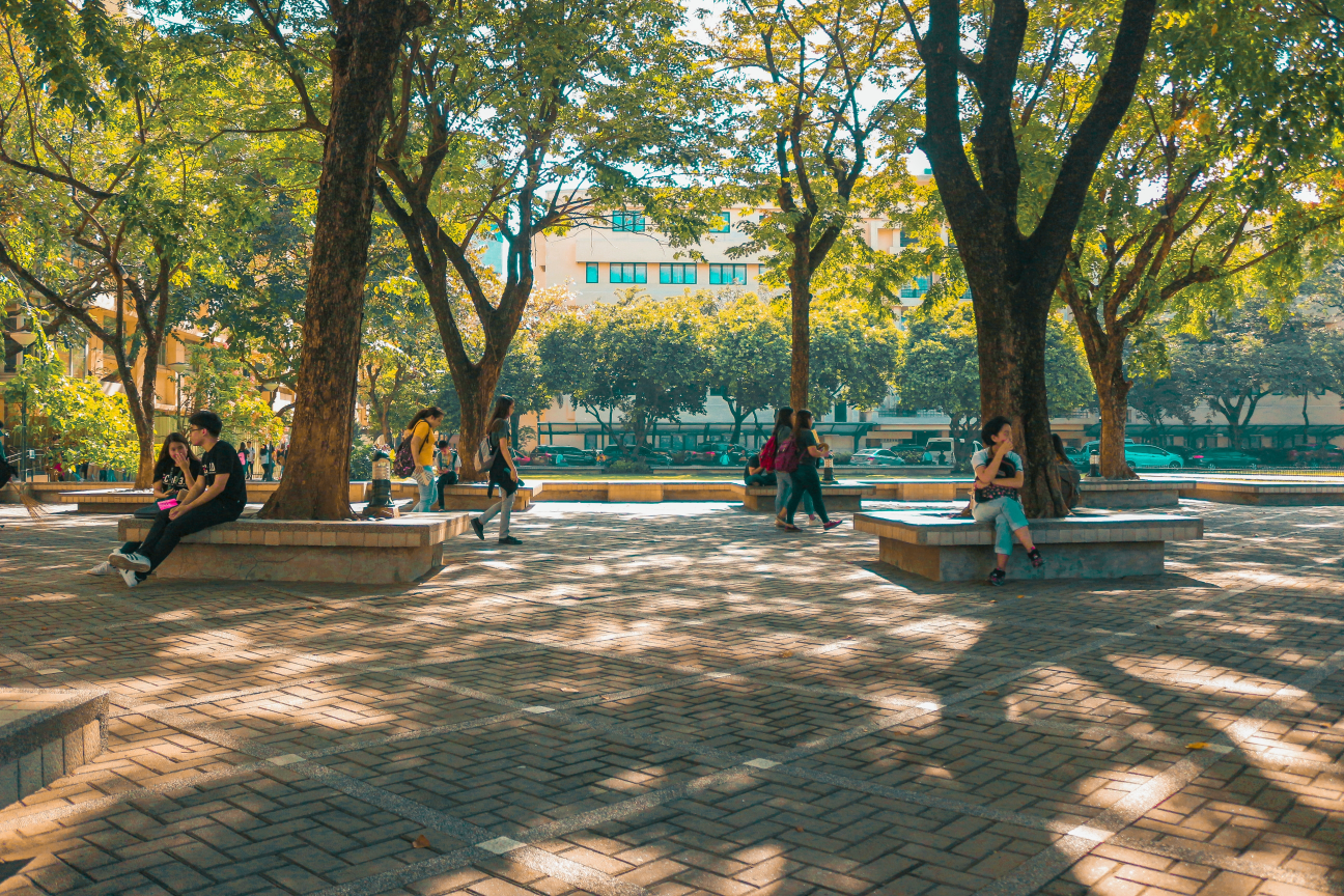 Students sitting and walking through a University courtyard