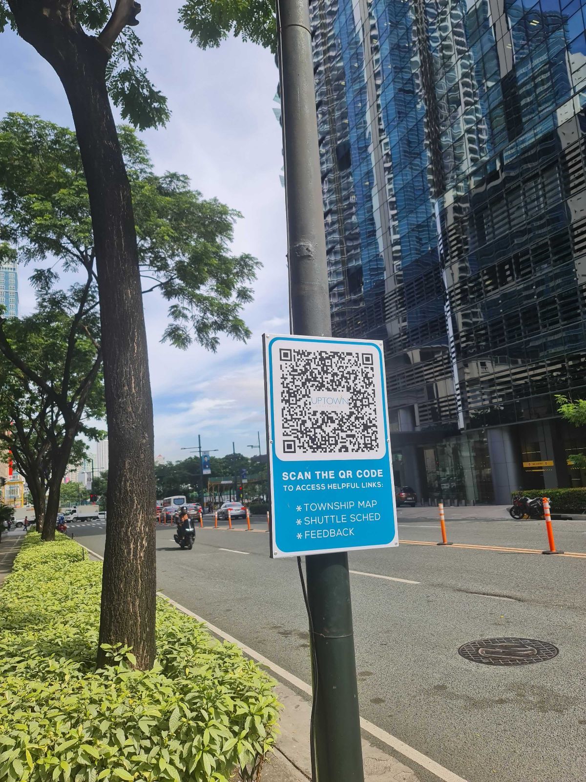A photo of a Megaworld QR code on a signpost outside