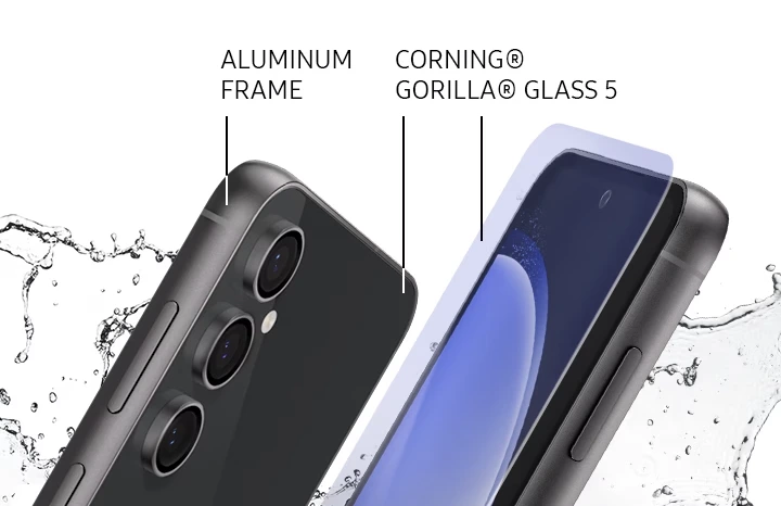 Two Galaxy S23 FE devices standing slanted next to each other. One is angled to show its rear and side labeled ALUMINUM FRAME. The other shows its front with a hovering display film labeled CORNING® GORILLA® GLASS 5. Splashes of water are surrounding the two devices.
