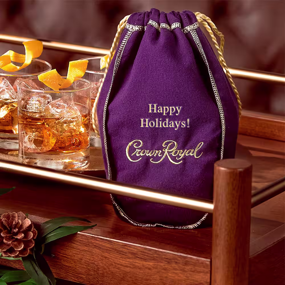 A engraved Crown Royal Purple bag with 'Happy Holidays!'