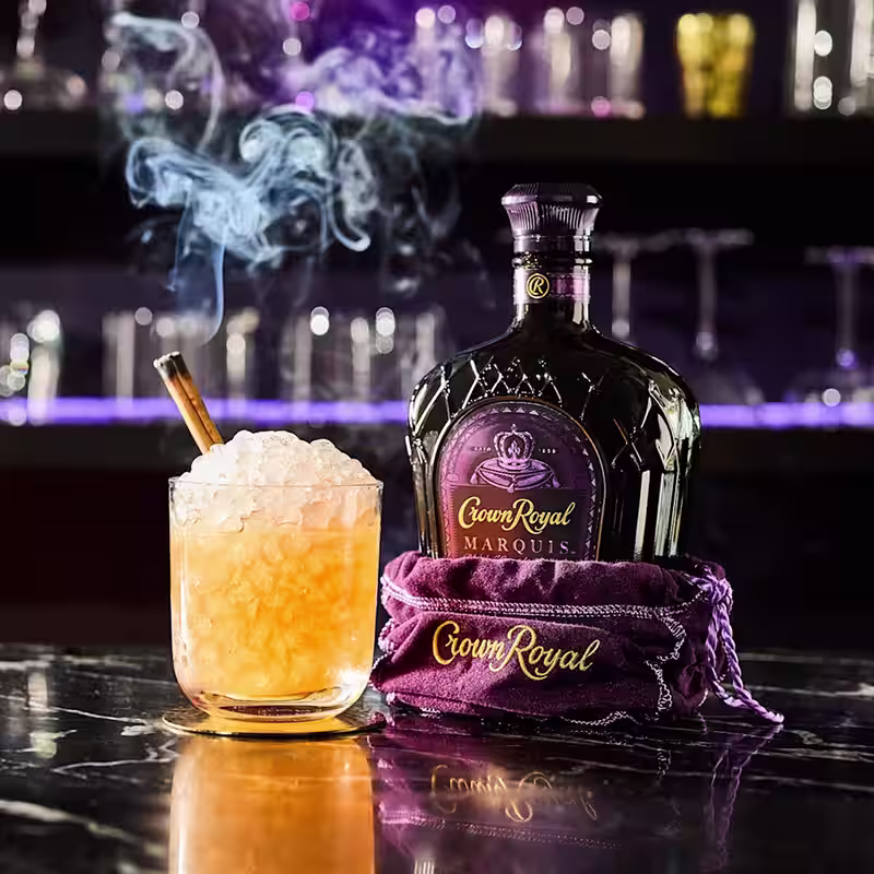 Crown Royal Marquis bottle with Crown Swizzle cocktail.