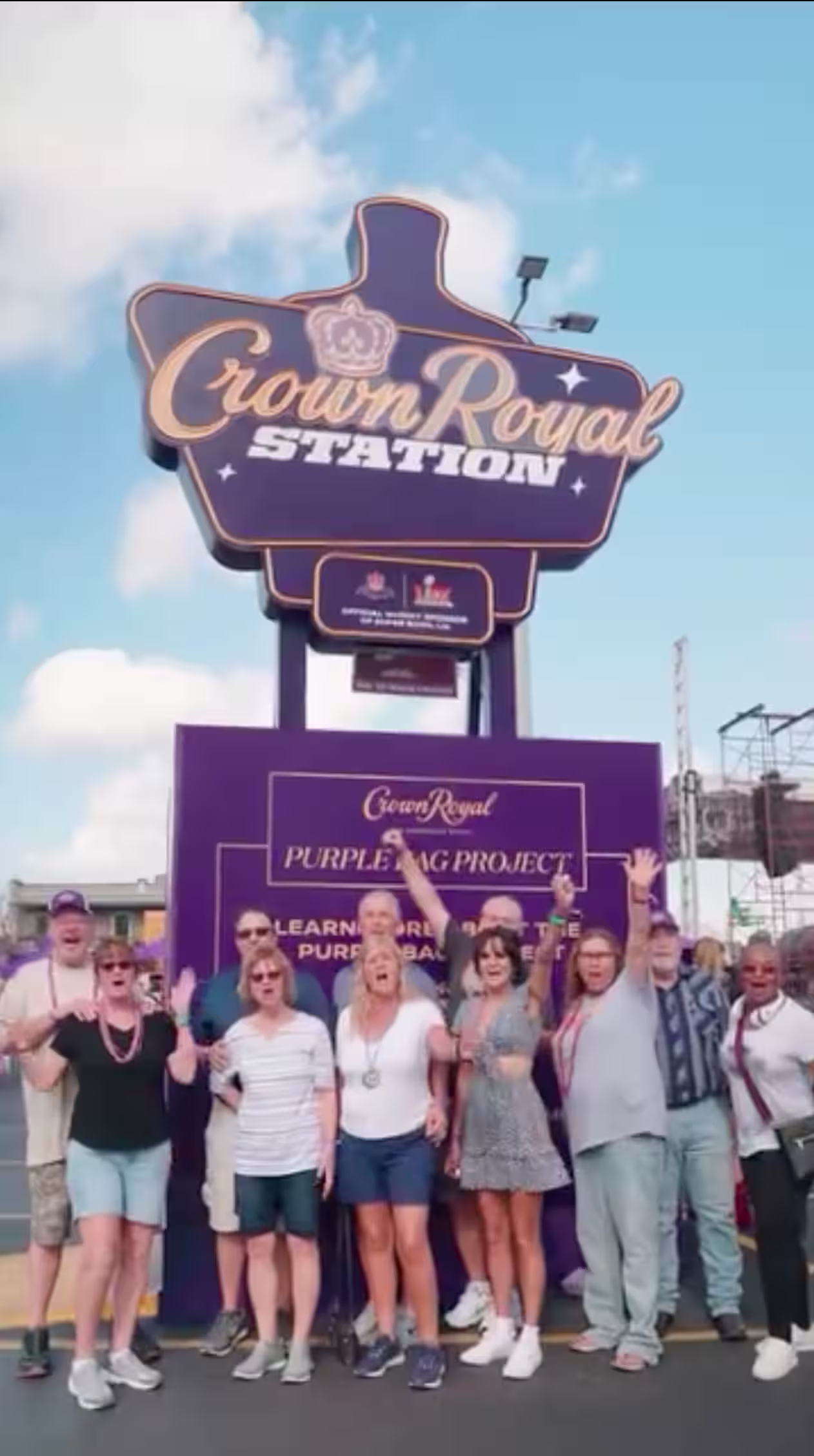People standing in front the Crown Royal Station sign