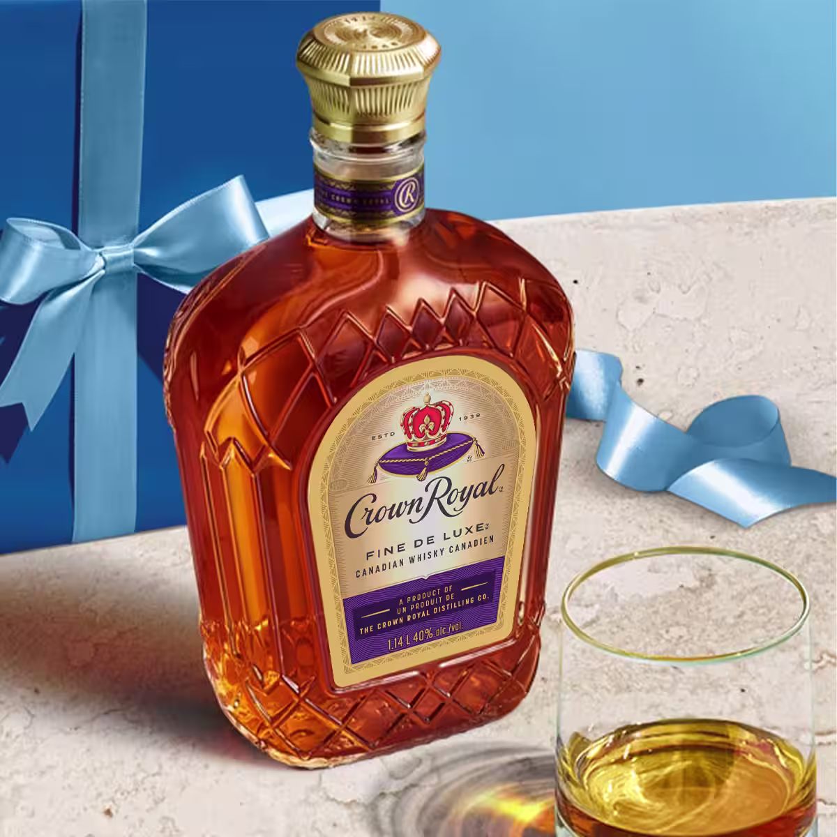 A bottle of Crown Royal Fine De Luxe laying on a table
