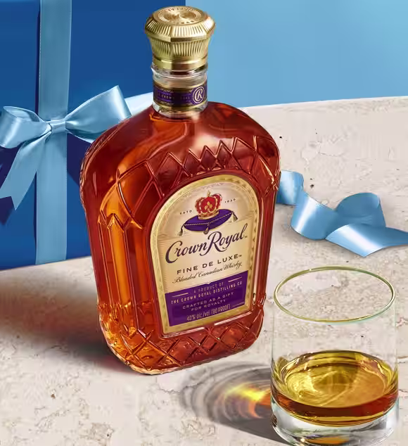 A bottle of Crown Royal Fine De Luxe laying on a table